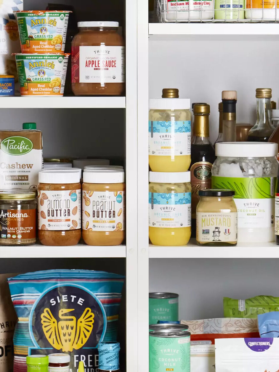 A white pantry filled with Thrive Market nonperishable food items.